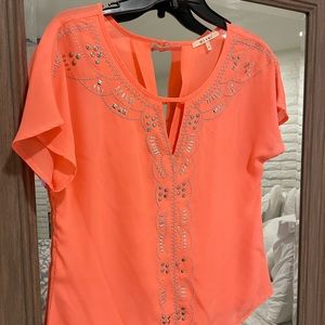 Tangerine color top.  Purchased at Francesca’s Boutique